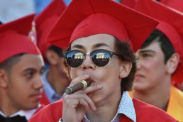 Graduation student smoking cigar red color